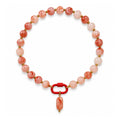 Coral pink and white acrylic beaded necklace with a pink oval pendant on a white background.