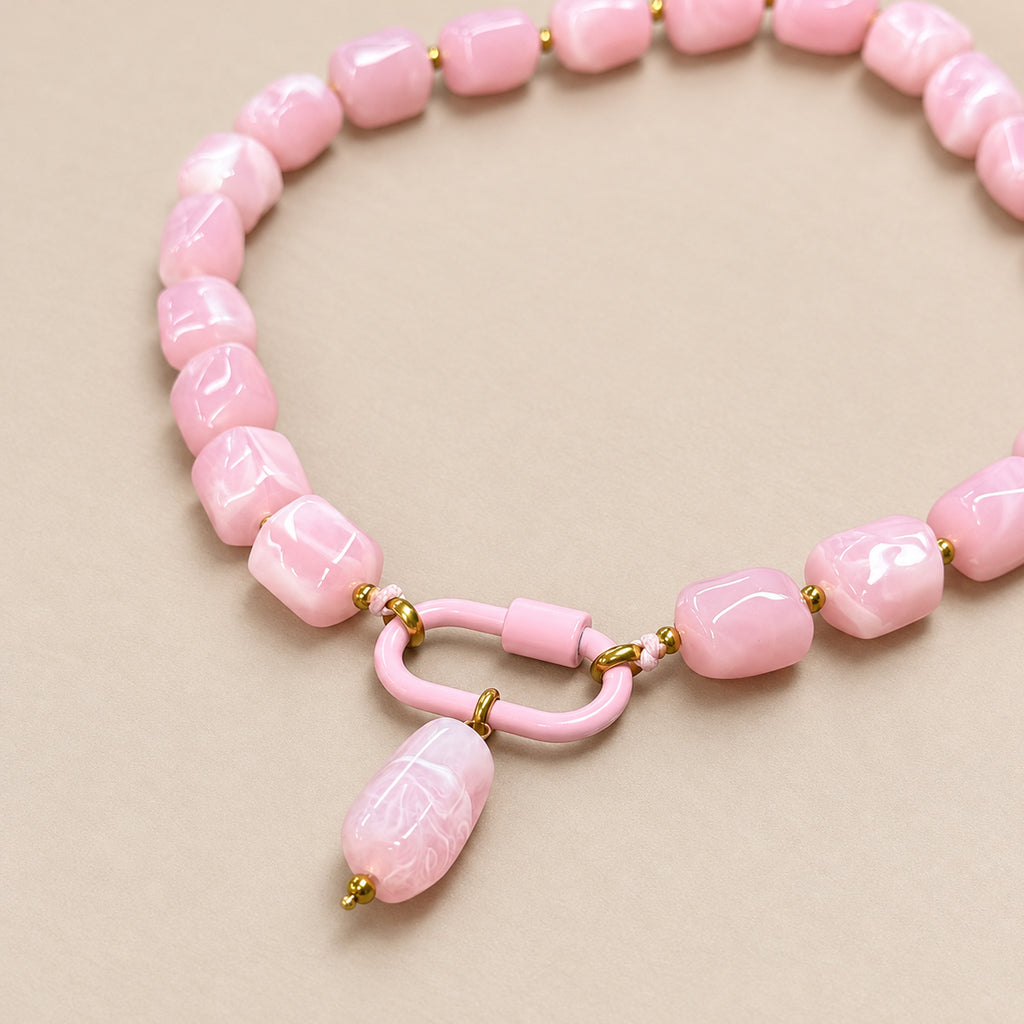 Close-up of the pink oval pendant, front clasp and acrylic beads.