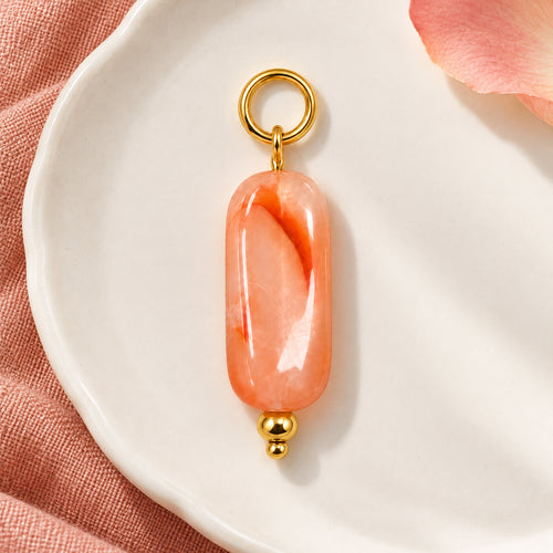 Coral Pink Oval Acrylic Pendant styled on a neutral background
