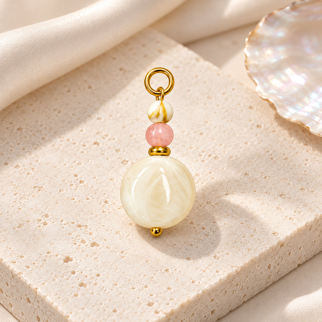 Cream and Pink Beaded Acrylic Pendant styled on a neutral background