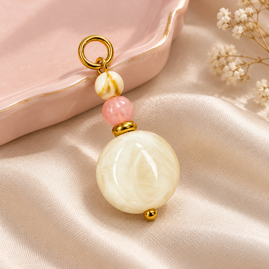 Cream and Pink Beaded Acrylic Pendant styled on a neutral background