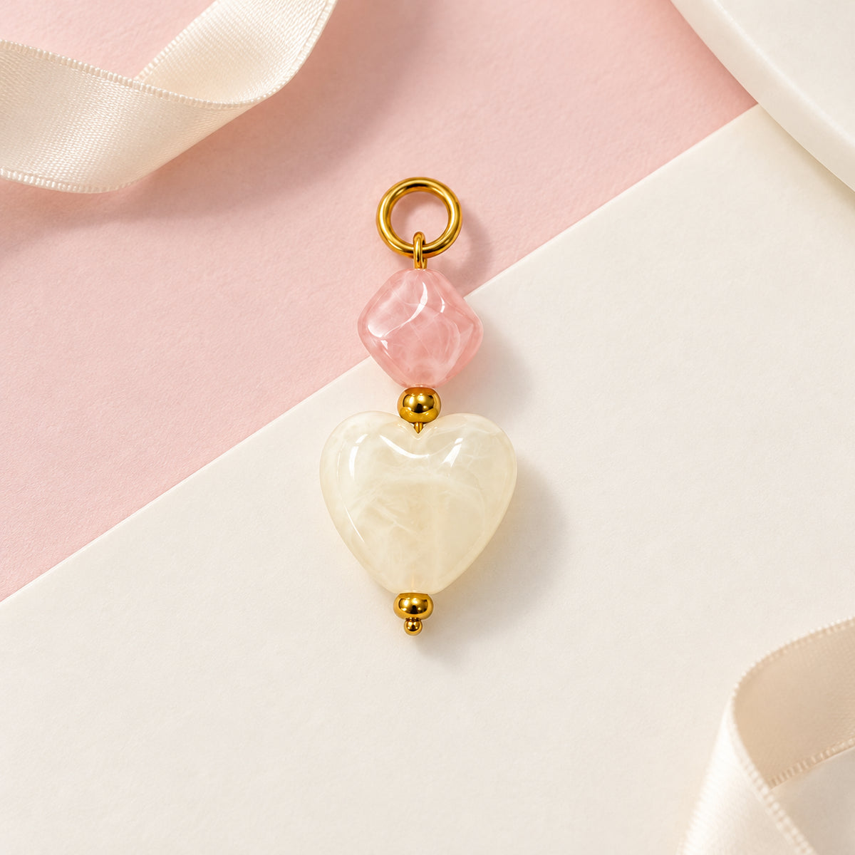 Pink and Cream Heart Acrylic Pendant styled on a neutral background