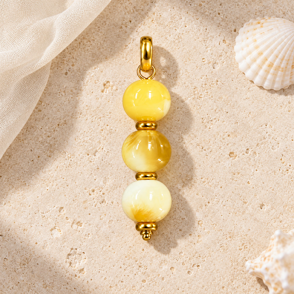 Yellow and Cream Beaded Acrylic Pendant styled on a neutral background